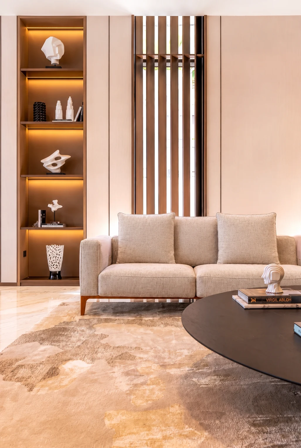 Jumeirah Bay Island Mansion — Illuminated display joinery and a slender timber screen give warmth and rhythm to the room.