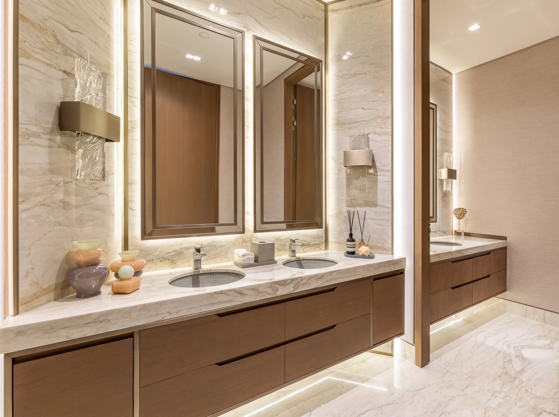Jumeirah Bay Island Mansion — Layered mirror and floor lighting brings a gentle clarity to the richly detailed stone.